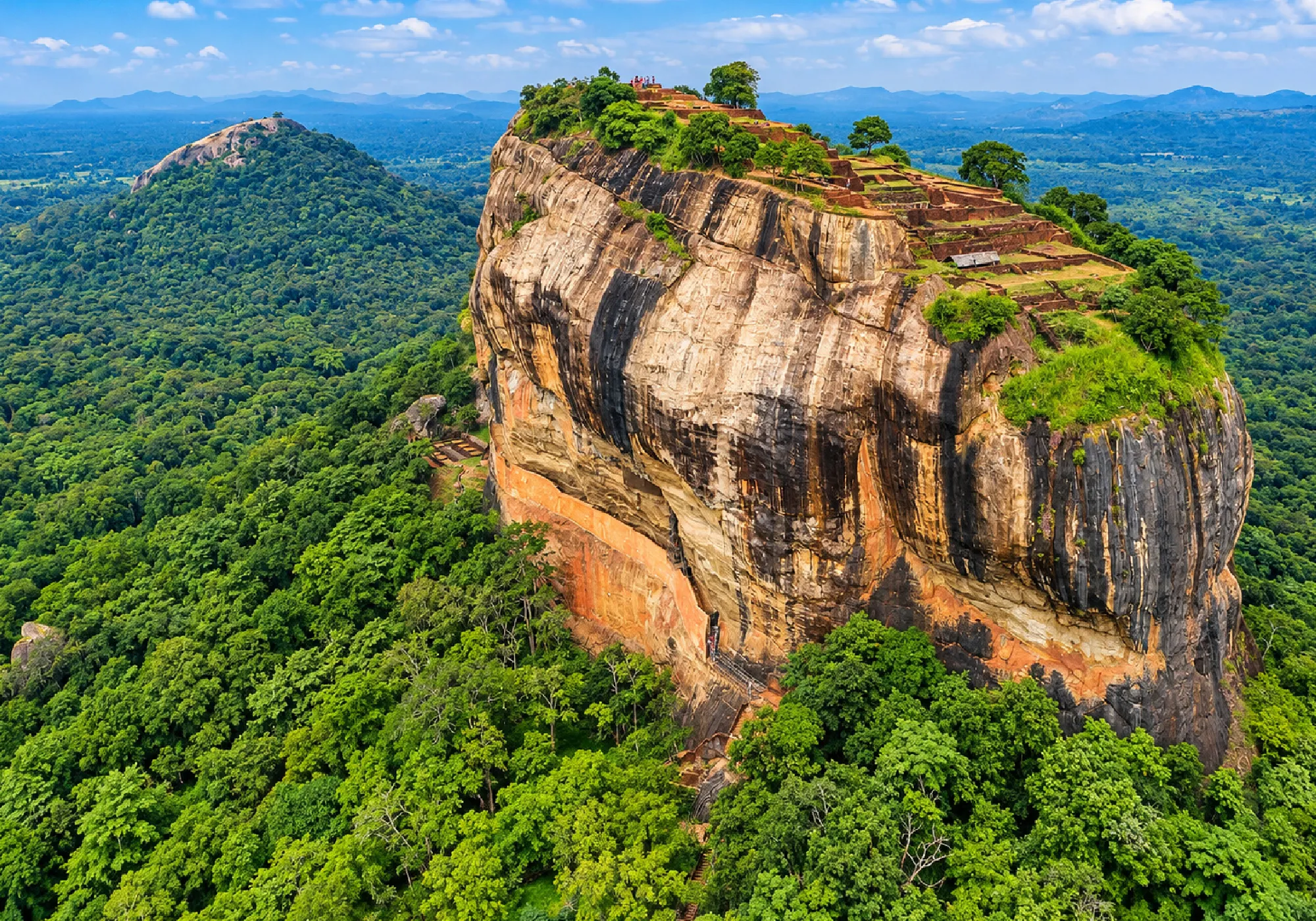 Sigiriya Rock Fortress in Sri Lanka surrounded by lush green landscapes